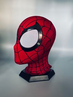 a spider - man mask is shown on a silver surface