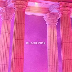 the pink light is shining on the pillars and walls in this room with columns that read blackpink