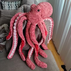 an octopus stuffed animal sitting on top of a couch