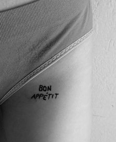 a woman's stomach with the words bon appetit written in black ink