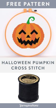 a spool of black thread next to an orange pumpkin cross stitch pattern on a white background