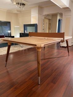 a wooden table sitting on top of a hard wood floor