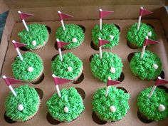 cupcakes with green frosting and golf flags on them in a box, ready to be eaten