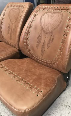 two brown leather seats sitting next to each other