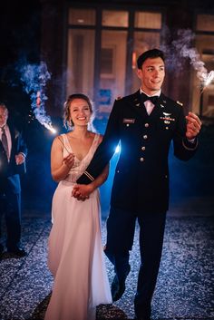 a bride and groom holding sparklers in their hands