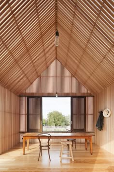 a room with wooden walls and tables in it