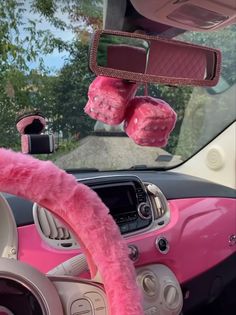 the interior of a car with pink fur trims and steering wheel covers on it