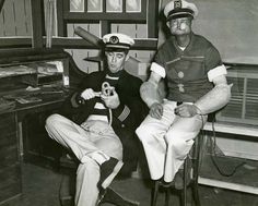 two men in uniforms sitting next to each other