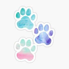 three watercolor paw prints on a white background with blue, pink and green colors