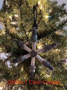 a snowflake ornament hanging from a christmas tree