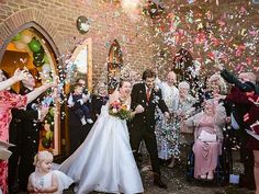 the bride and groom are surrounded by confetti