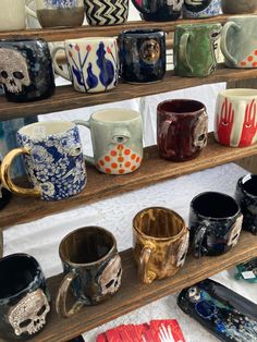 many different colored coffee mugs are on shelves