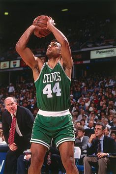 the basketball player is getting ready to dunk the ball in front of an audience