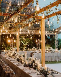 a long table is set with candles and flowers for an elegant wedding reception in the garden