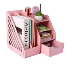 a pink desk organizer with books and pencils