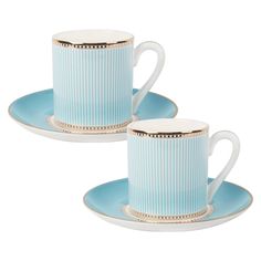 two blue cups and saucers with gold trimmings on the sides, sitting side by side