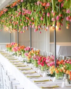 the tables are set with flowers and place settings for guests to sit down at them