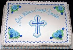 a cake decorated with blue roses and a cross on it that says, god's joseph ronald