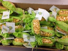 several bags filled with corn sitting on top of each other in front of a box