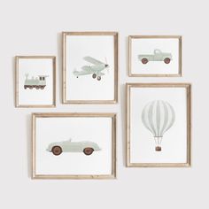 four framed pictures with cars and hot air balloons hanging on the wall in front of them