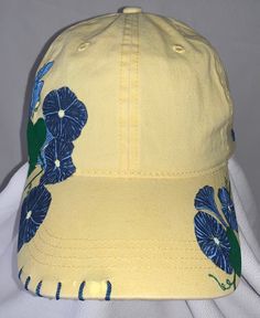 "Good Morning, Glory" women's adjustable ball cap shown in yellow. This baseball cap features beautiful clusters of morning glories that have been wood burned, and then precision dyed and painted by hand. The unique stitching and handmade charm make this cap a must-have for all the morning people out there. Available in yellow (shown), lavender, pink and white. Please note that charms may vary from what is shown depending on supply. ALL designs are fully customizable; Personal color options may be made-to-order. Custom orders can take up to two weeks to create.  Email SouthernSunshineCustoms@gmail.com with any questions, or to discuss custom order options.  Return Policy We will accept returns of item if notified within 14 days. Buyer to pay all costs associated with return shipping. Funds Womens Ball Caps, Morning People, Morning Glories, Hand Burn, Personal Color, Lavender Pink, Womens Baseball Cap, Handmade Charms, Morning Glory