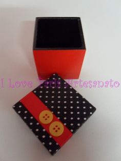 an orange and black box sitting on top of a white table next to a polka dot square