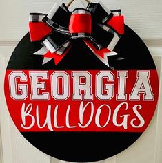 a red and black door hanger with the word georgia bulldogs on it