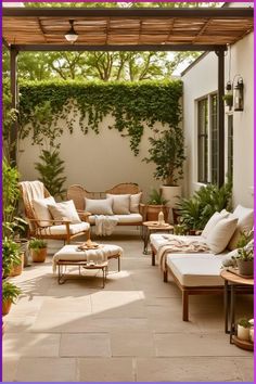 an outdoor living area with wicker furniture and potted plants on the side wall