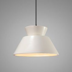 a white pendant light hanging from a black wire on a gray wall with a grey background