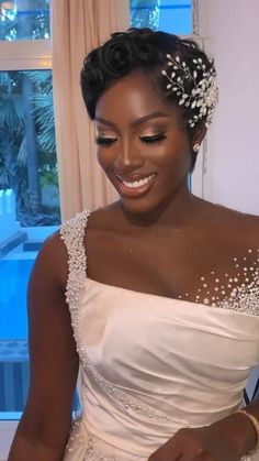 a woman in a wedding dress cutting into a cake