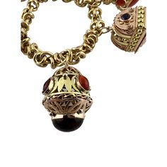 This beautiful mid century modern Etruscan revival bracelet is set in 18K yellow gold.   This heavy bracelet is set with assorted semi precious stones. - light scratching, chips to some stones as shown  2 of the charms open as shown.   8" in length from end to end, approx. 7" wrist size  106.8 g / 68.6 dwt  Stamped 750  Charms up to 35mm in length and 24mm wide  Bracelet is approx. 11mm wide  Very good preowned condition. Just polished by our jeweler.  Will be shipped express mail with insurance Antique Round Gemstone Bracelets, Antique Gemstone Bracelets, Collectible Jeweled Bracelet, Collectible Jewelry With Jewels, Collectible Jewels Bracelet, Antique Multi-stone Gold Jewelry, Antique Gold Multi-stone Jewelry, Ornate Pendant Jewelry With Vintage Charm, Ornate Vintage Charm Pendant Jewelry