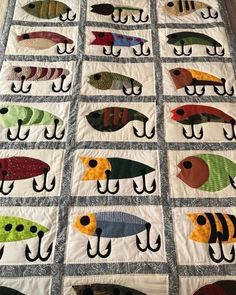 a quilt made to look like fish on a fishing hook, with different colors and sizes