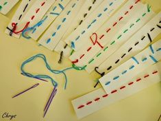 many pieces of paper are laid out on the table with crochet hooks and yarn