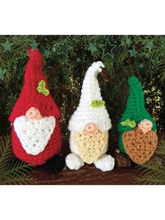 three crocheted gnomes sitting next to each other