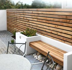 a wooden bench sitting next to a white table