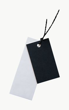 a black and white tag hanging from a string