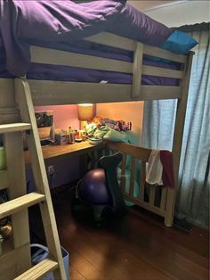 there is a bunk bed in the room with a desk and chair next to it