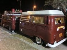 an old vw bus is parked on the side of the road at night time