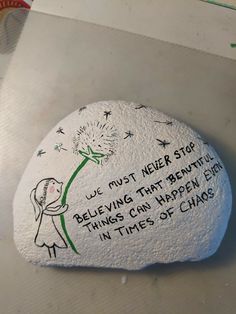 a rock with writing on it that says, we must never stop believing that beautiful things can happen in times of chaos