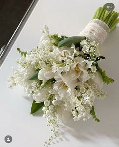 a bouquet of white flowers sitting on top of a table