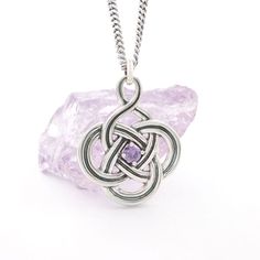 Beautiful striking pendant using a combination of black oxidation and polished sterling silver. The inner frame is decorated with your choice of purple, green, or blue, sparkling cz stone. The intricate knot work is a variation on the classic quaternary Celtic knot representing strength, protection, and eternal life. The pendant has a very graceful shape, ultra feminine with wonderful proportions and symmetry.The 20" substantial oxidized chain completes the look to perfection. Matching earrings available to complete the set Diamond Claddagh Ring, Mens Claddagh Ring, Claddagh Ring Wedding, Celtic Love Knot, Celtic Knot Necklace, Celtic Engagement Rings, Celtic Knot Pendant, Celtic Trinity Knot, Celtic Necklace