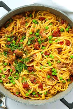 pasta with peas and meat in a skillet