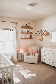 a baby's room with a crib, dresser and chair in it is shown