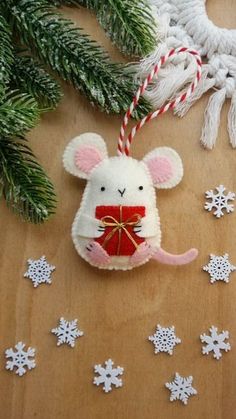 a mouse ornament hanging from a christmas tree