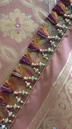 the fabric has been stitched together with tassels and bead work on it