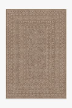 a beige rug with an intricate design on it