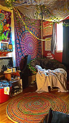 a room with various items and decorations on the walls, including a bed covered in a colorful blanket