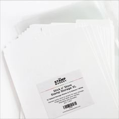 a stack of white folders sitting next to each other on top of a table