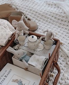 a basket filled with baby items on top of a bed