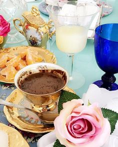 a table topped with plates and cups filled with food